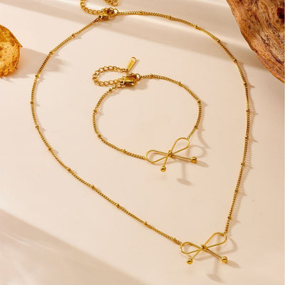 Collier et bracelet femme en acier au titane plaqué or 18 carats